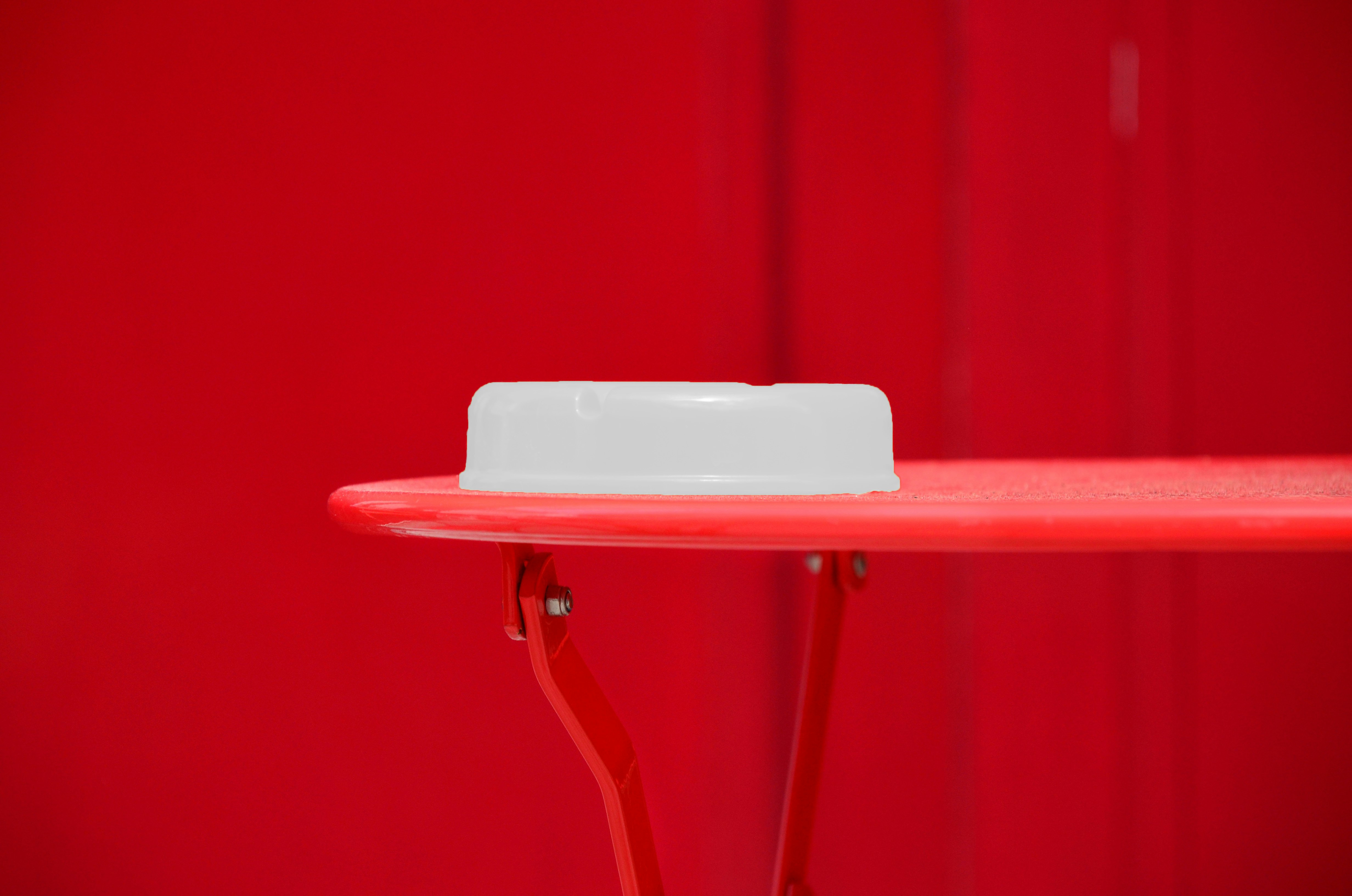 round white plastic container on red table